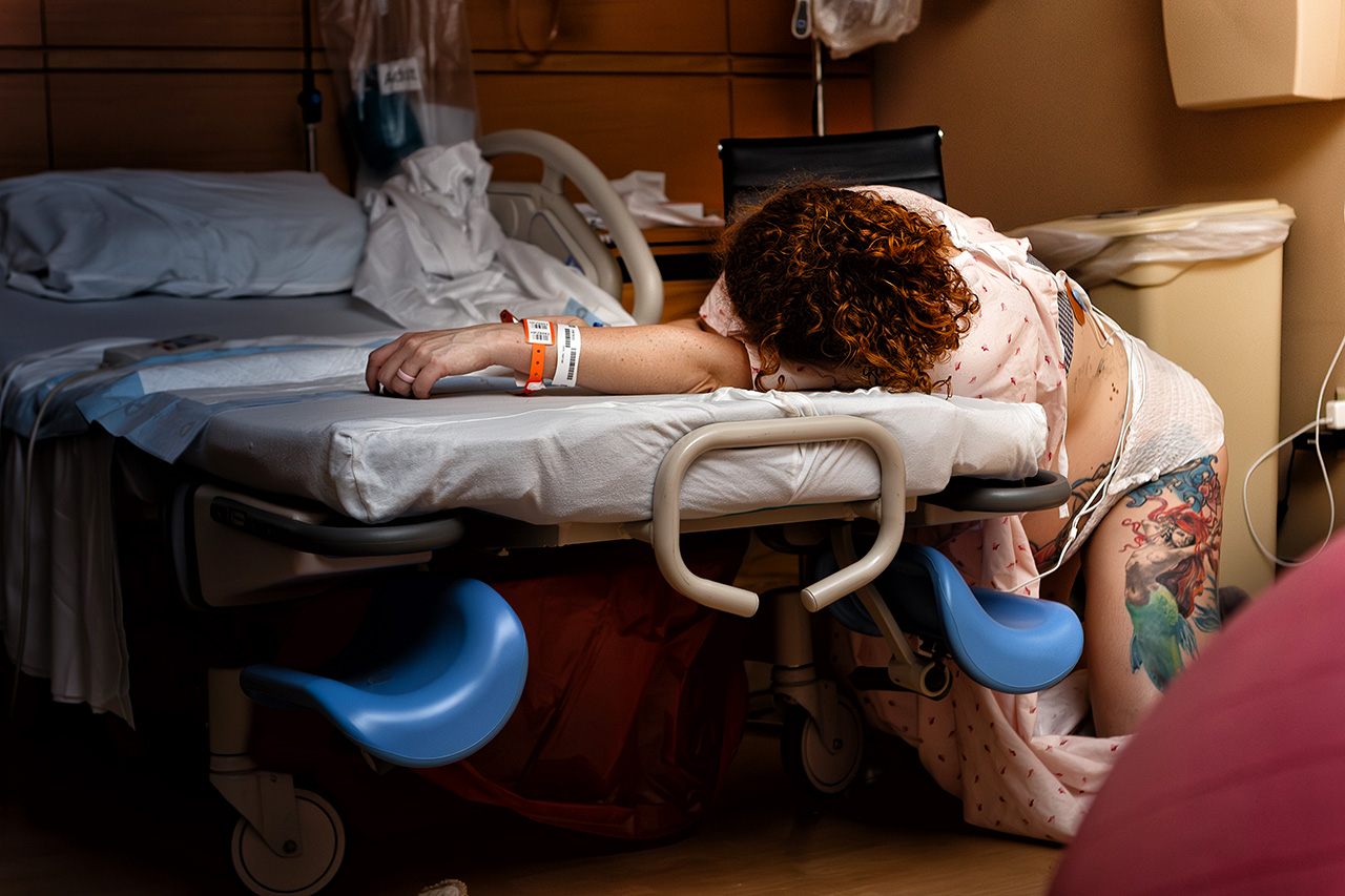 Hospital birth photo of a woman stretched out during labor by Leona Darnell.