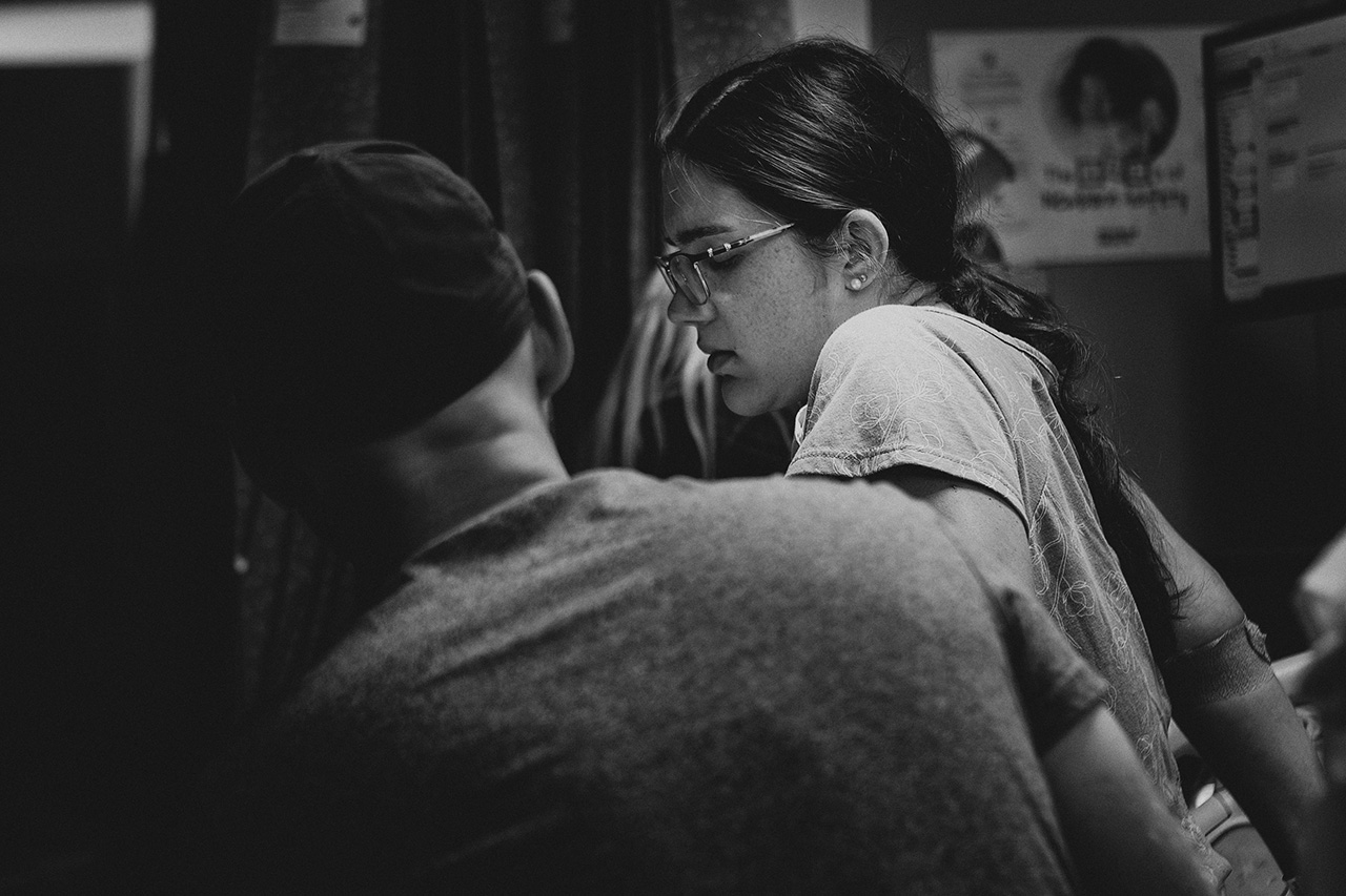 A black and white birth image of a woman laboring in the hospital with her partner. Image by Birth and Beauty.