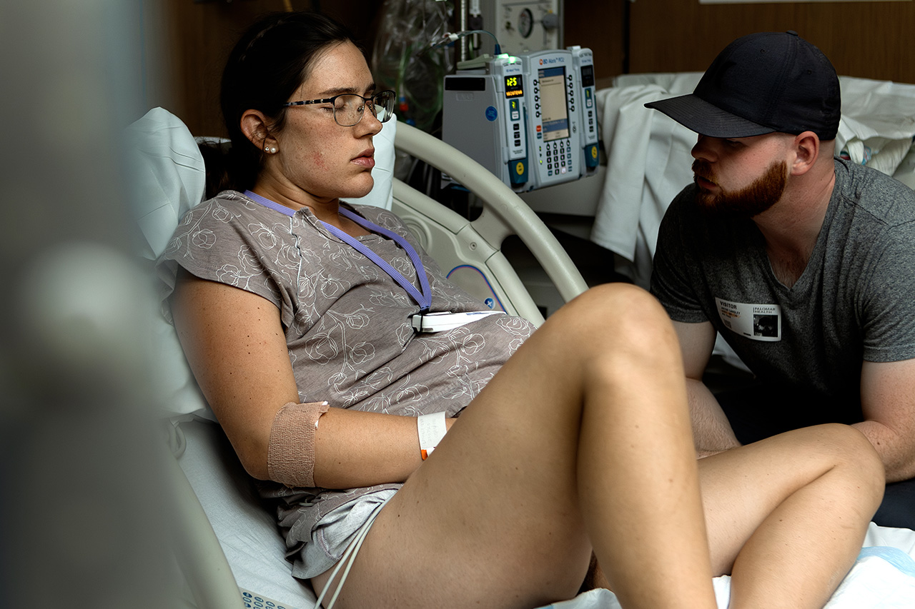 A color birth photo of a woman laboring peacefully with her husband during a woman lead hospital birth. Image by Los Angeles birth photographer, Leona Darnell. 