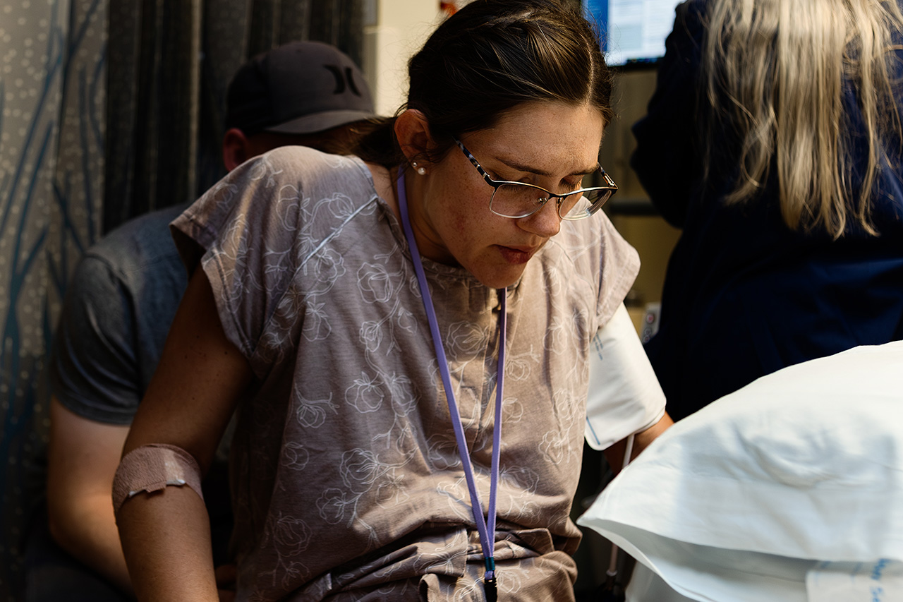 A color birth photo of a woman during active labor by birth photographer, Leona Darnell